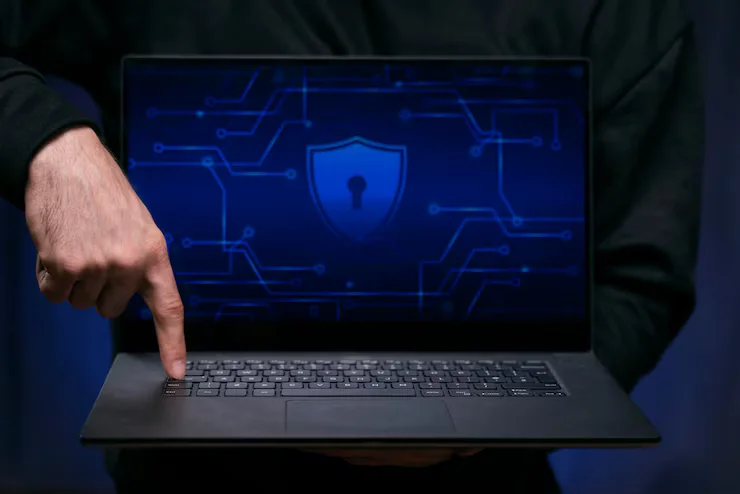 Laptop showing a digital security shield icon representing cybersecurity protection by Brilliant Technologies.